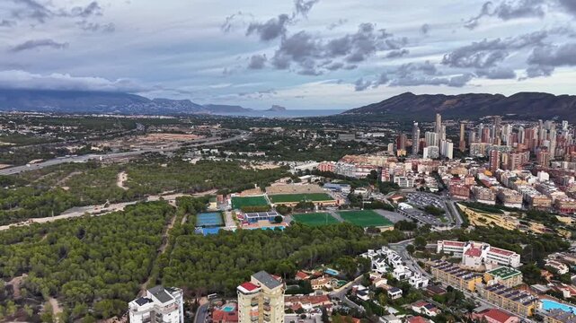 aerial footage showcasing development of recreational zones around urban outskirts under cloudy