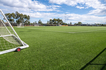 Obraz premium A multiple artificial turf soccer pitches at a suburban sports complex with portable goalposts in Melbourne, Australia. Community sporting infrastructure and public recreational facility