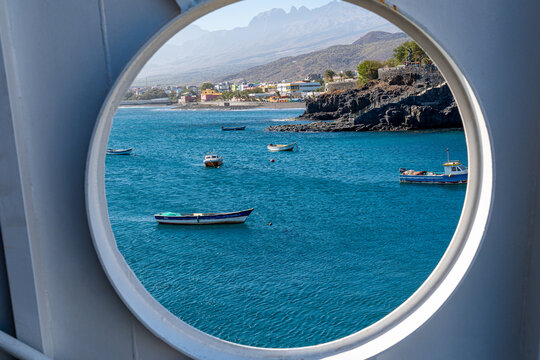 Beautiful view of Porto Novo with small fishing boats seen through the round window of a ferry boat that makes the crossing between S&atilde;o Vicente Island and Santo Ant&atilde;o, Cape Verde.