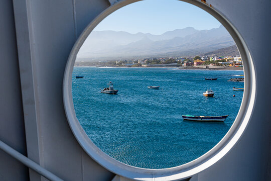 Beautiful view of Porto Novo with small fishing boats seen through the round window of a ferry boat that makes the crossing between S&atilde;o Vicente Island and Santo Ant&atilde;o, Cape Verde.