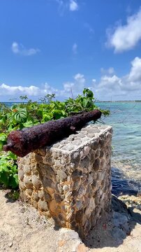 Historic Antique Cannon Facing the Turquoise Caribbean Sea in Akumal, Mexico