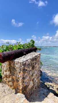 Historic Antique Cannon Facing the Turquoise Caribbean Sea in Akumal, Mexico