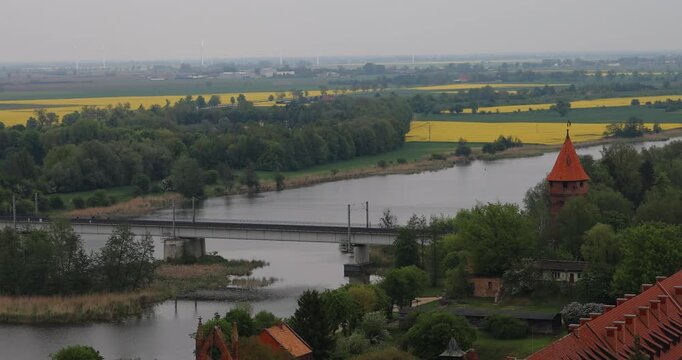 Poland Malbork railroad bridge river crossing.. Medieval castle of Teutonic Order in Malbork, Brick Gothic complex 13th century. Largest castle in the world. Destroyed in WW II. Historical buildings.