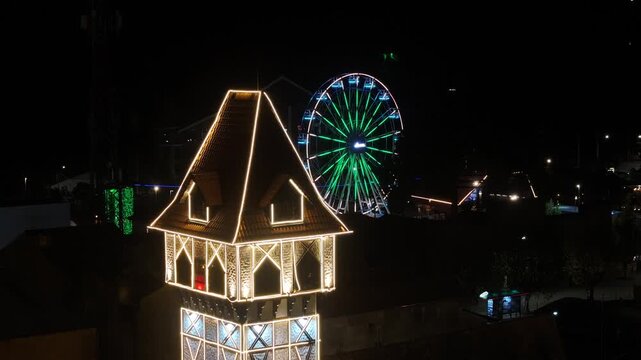 Night View Of Capivari Village In Campos Do Jordao In Sao Paulo Brazil. Illuminated Ferris Wheel. Downtown Cityscape. European Architecture. Capivari Village In Campos Do Jordao In Sao Paulo Brazil. 
