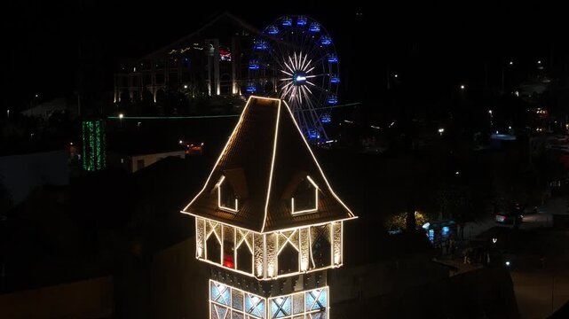 Night View Of Capivari Village In Campos Do Jordao In Sao Paulo Brazil. Illuminated Ferris Wheel. Downtown Cityscape. European Architecture. Capivari Village In Campos Do Jordao In Sao Paulo Brazil. 