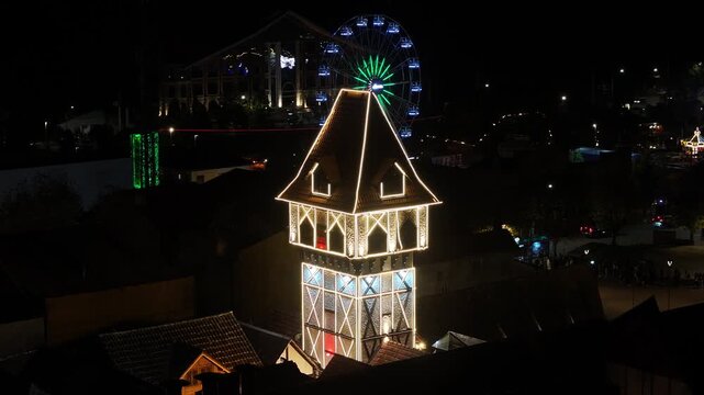 Night View Of Capivari Village In Campos Do Jordao In Sao Paulo Brazil. Illuminated Ferris Wheel. Downtown Cityscape. European Architecture. Capivari Village In Campos Do Jordao In Sao Paulo Brazil. 