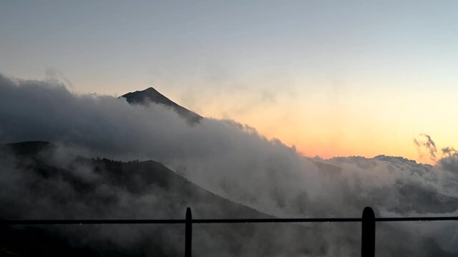 Teide volcano peak at sunset above moving cloud inversion in Tenerife