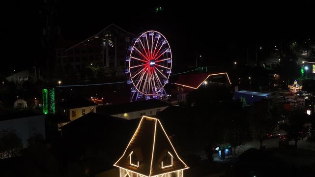 Night View Of Capivari Village In Campos Do Jordao In Sao Paulo Brazil. Illuminated Ferris Wheel. Downtown Cityscape. European Architecture. Capivari Village In Campos Do Jordao In Sao Paulo Brazil. 