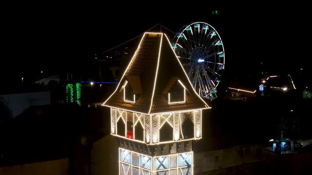 Night View Of Capivari Village In Campos Do Jordao In Sao Paulo Brazil. Illuminated Ferris Wheel. Downtown Cityscape. European Architecture. Capivari Village In Campos Do Jordao In Sao Paulo Brazil. 