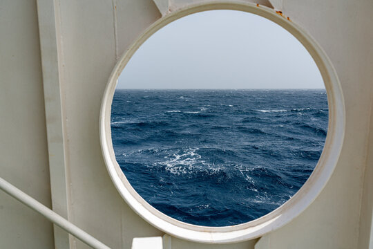 View of the sea through the round window of a ferry boat that makes the crossing between S&atilde;o Vicente Island and Santo Ant&atilde;o