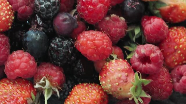 Various fresh summer berries backgrounds. Strawberry, blueberry, raspberry red currant and blackberry mix. Top view, flat lay.