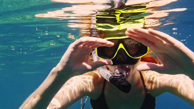 Woman with snorkeling mask smiling underwater