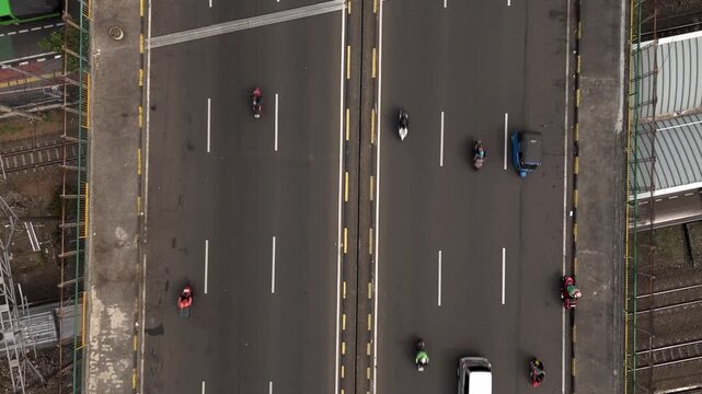 Color graded top down aerial view of city highway bridge with traffic moving on asphalt lanes