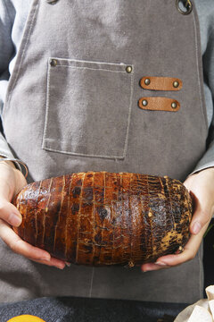 Fresh Taro Root from Guangxi Held by Chef in Kitchen Apron - Traditional Asian Vegetable Ingredient