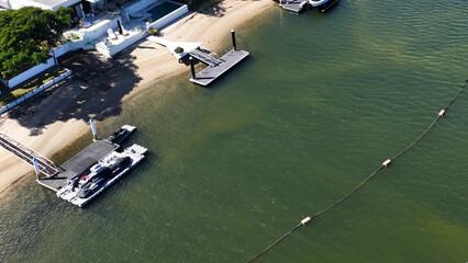 Aerial View of Waterfront Homes and Sand Bypass Pipe in Gold Coast © blueringmedia