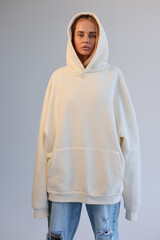 Fototapeta premium Oversized Hoodie Mockup On Female Model Blank Beige Hooded Sweatshirt Streetwear Style