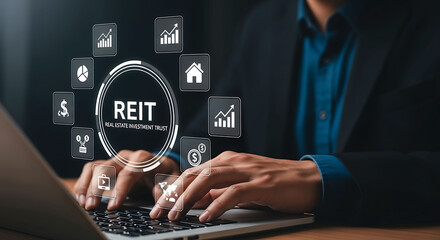Naklejka premium Businessman using laptop with REIT Real Estate Investment Trust virtual interface