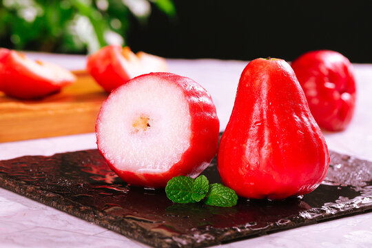 Fresh Red Wax Apples Lotus Fruit from Hainan on Slate Board with Mint Garnish