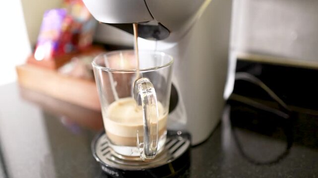 Automatic Coffee Machine Pouring Fresh Espresso Into a Clear Glass Mug