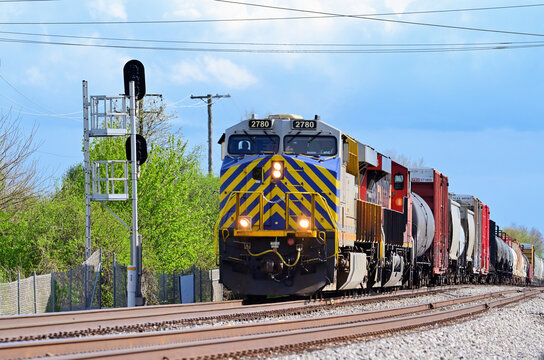 With the lead locomotive featuring safety striping, Canadian National Railway unitss lead a freight train norththbound through southwest suburban Chicago. 