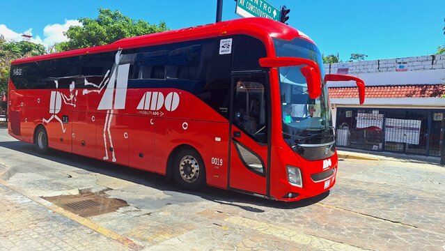 Red ADO bus on Playa del Carmen street