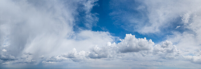 Fototapeta premium Panoramic Blue Sky With Dramatic White Clouds Overhead — Cloudscape and Atmospheric Horizon