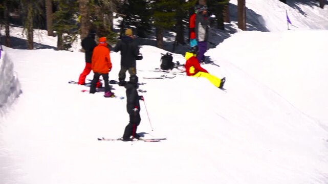 Snowboarder in pink doing bir air tricks in the snow