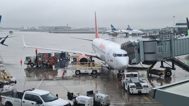 Airplane at Toronto Pearson International Airport gate on a rainy day