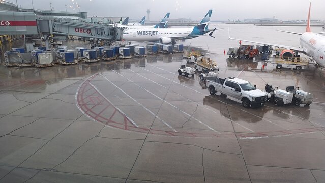 Airplanes at Toronto Pearson International Airport on a rainy day.