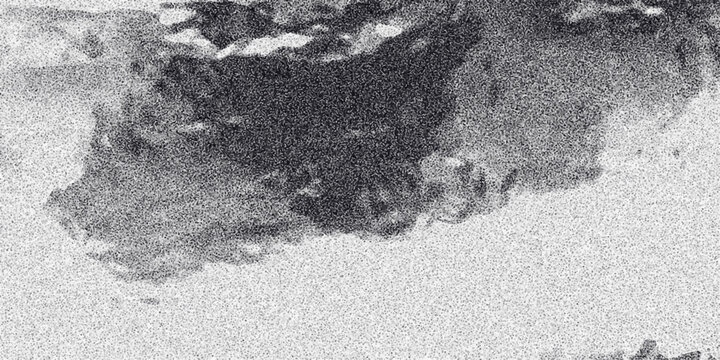 Abstract grayscale dark cloud formation with grainy texture and diffused light creating a dramatic or stormy atmospheric background