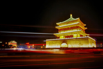 Fototapeta premium Bell Tower of Xi'an illuminated at night with traffic light trails