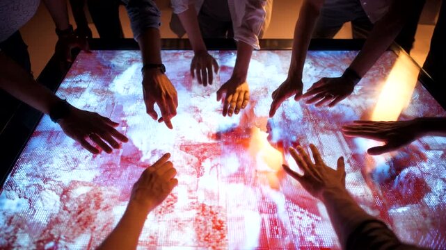 Group of people interacting with a digital display