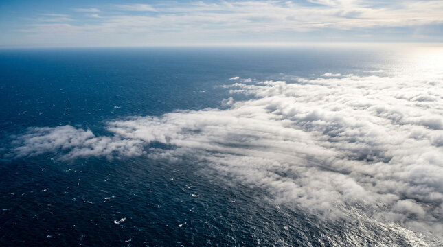 Aerial view of clouds slow movement on a sea background.
