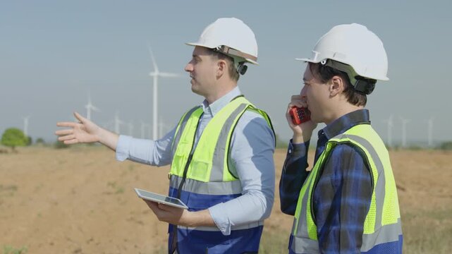 Wind Turbine energy system for sustainable development goals, wind turbine engineer inspection renewable energy field hard hat safety vest outdoor walkie talkie site clean power field turbine