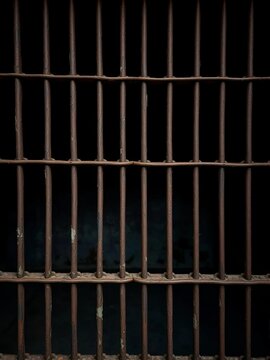 Rusty metal bars of a jail cell against a dark, oppressive backdrop,  confinement,  safety