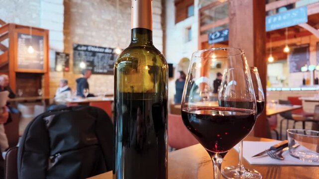Red Wine Bottle and Glass on Table in Saint Emilion Bistro