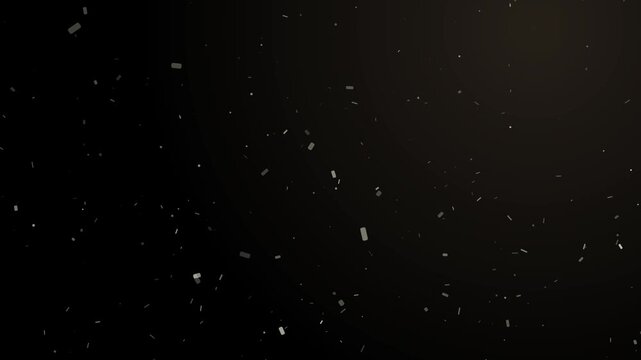 Abstract light beam illuminates gently floating dust particles on a dark background motion