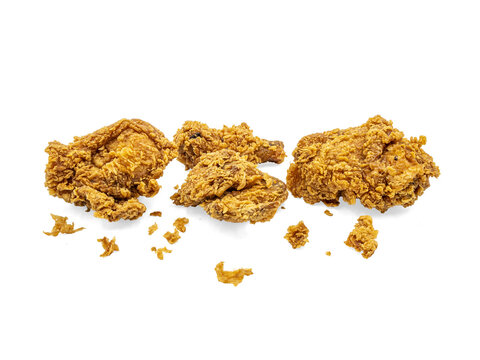 Crispy fried chicken pieces with crumbs scattered, isolated On Transparent Background, close-up food cutout for fast food or restaurant menu design.