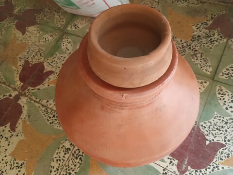 Traditional Terracotta Water Pot On Tiled Surface