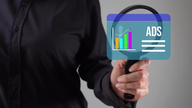 Close-up of a woman's hand with a magnifying glass analyzing an animation of an ADS graphic analysis web interface