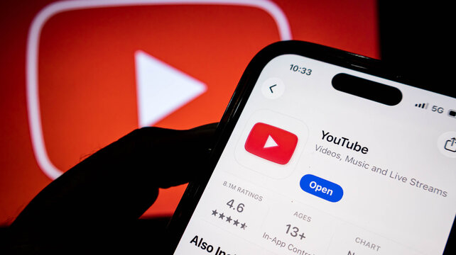Closeup of a smartphone screen displaying the youtube app store page with the app icon, rating, and open button visible