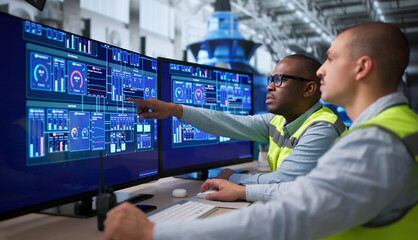 Two Engineers Are Reviewing Data On Computer Screens © Andrey Popov