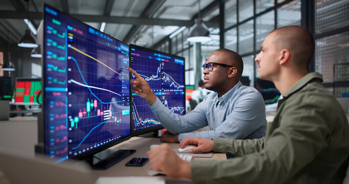 Two Financial Analysts Discuss Stock Trends While Studying Data