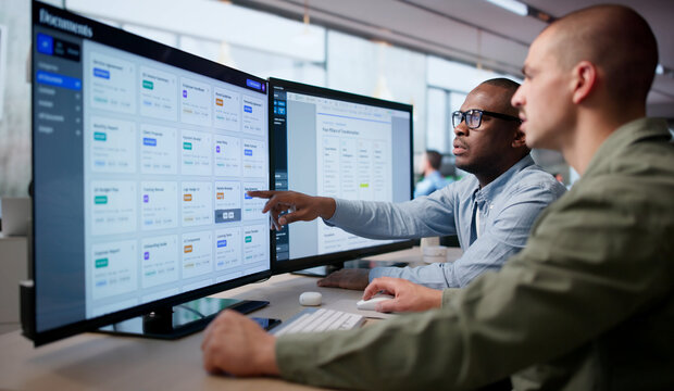 Two Men Work Together Managing Secure Digital Documents