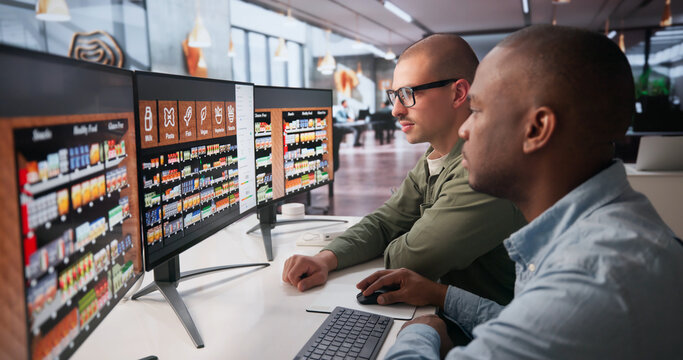 Retail Manager And Assistant Discuss Store Layout While