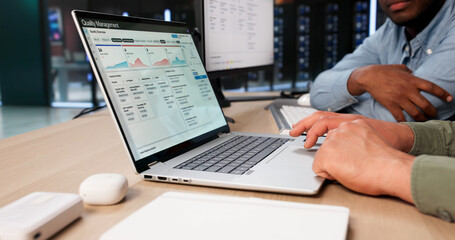Two Young Men Review Corrective Actions Using QMS Software