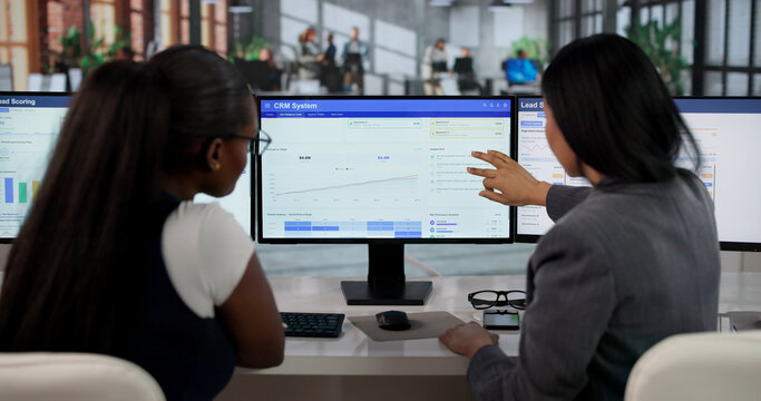 Sales Manager Guides Diverse Team Using CRM Software