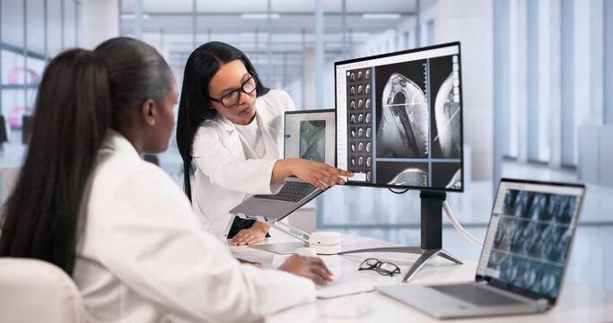 Doctor And Technician Studying Shoulder MRI