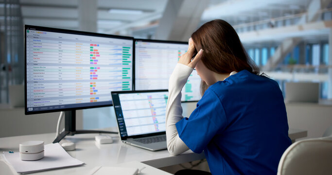 Tired Nurse Monitors Patient Data