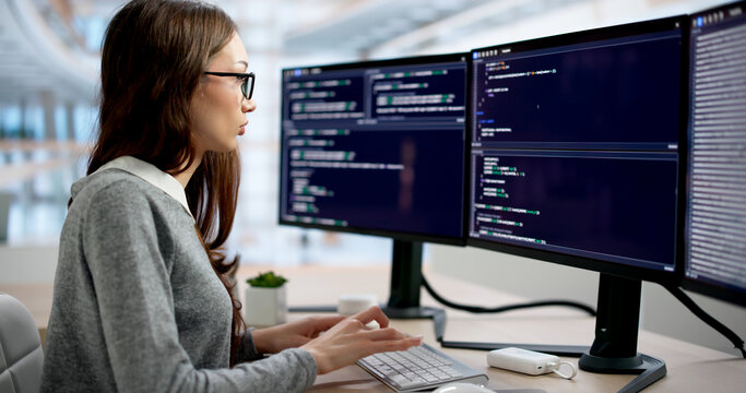 Young Female Software Engineer Coding Quickly